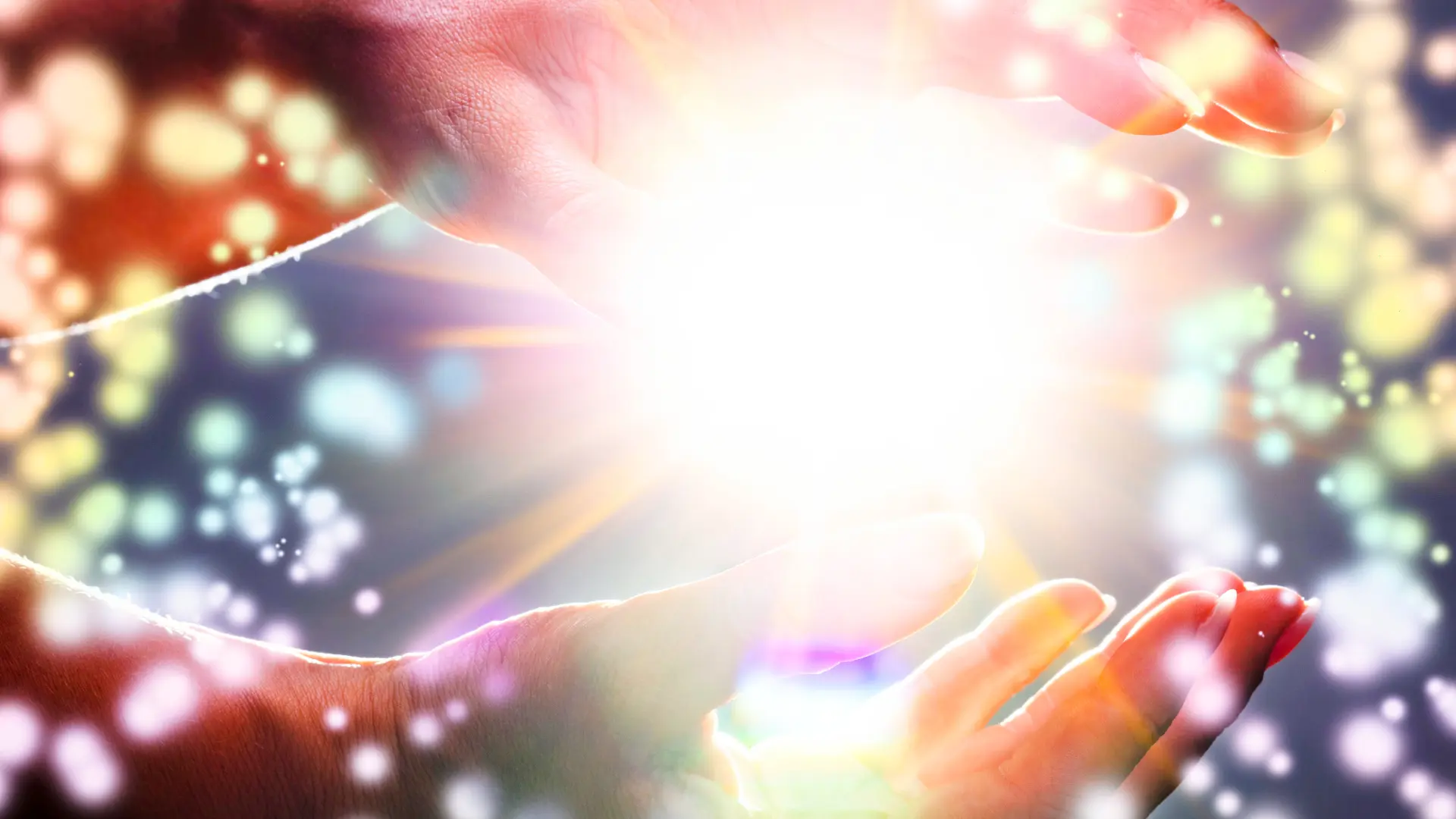 Hands emitting glowing light and colorful energy particles, symbolizing Low-Level Laser Therapy (LLLT) for chronic pain healing – Chronic Health Wisdom