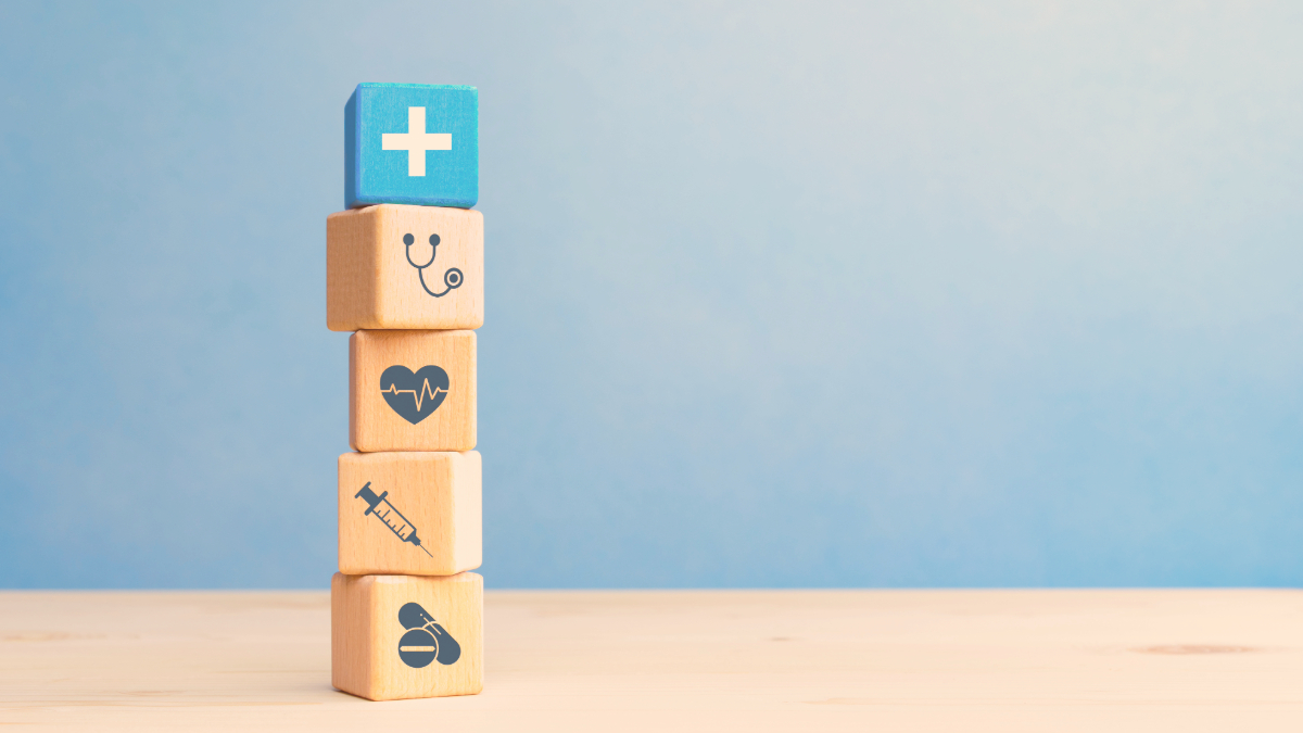Picture of healthcare icons on cubes with a blue background.